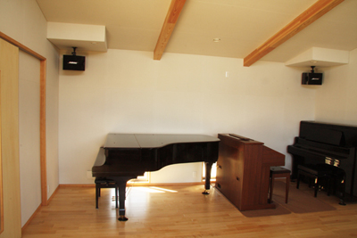 グランドピアノ、オルガン、アップライトピアノと並ぶアトリエ。